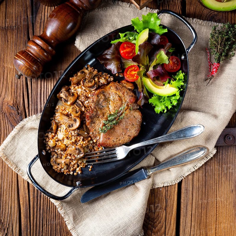 Pork steak with mushrooms and buckwheat groats and mango salad