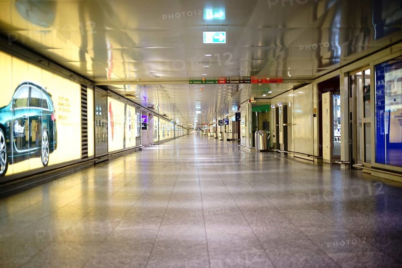 Frankfurt, Germany - November 25, 2016: An subway or connecting tunnel of individual airport terminals at Frankfurt Airport decorated with advertising posters on 25 November 2016 in Frankfurt