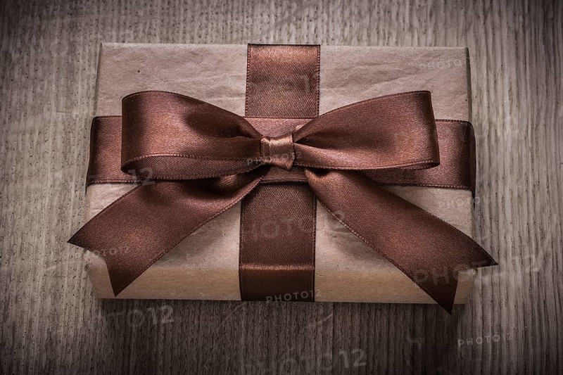 Boxed vintage gift container with brown ribbon celebration concept
