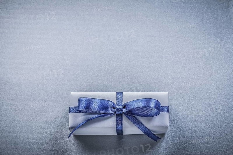 Wrapped gift box on blue background holidays concept
