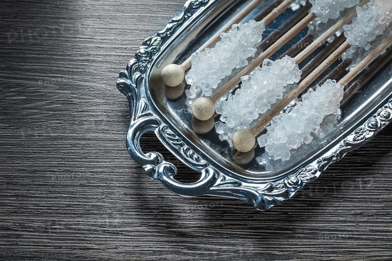 Tasty sugar sticks on metallic tray