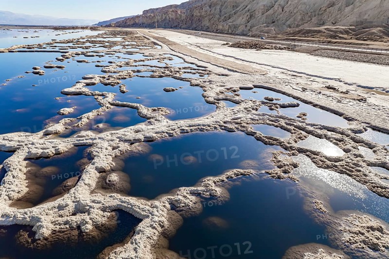 Dead Sea. The drainless salt lake in the Middle East, the saltiest lake in the world. On the surface of the water, the evaporated salt forms bizarre crystal shapes. Israel. The picture was taken by a drone from a aerial view