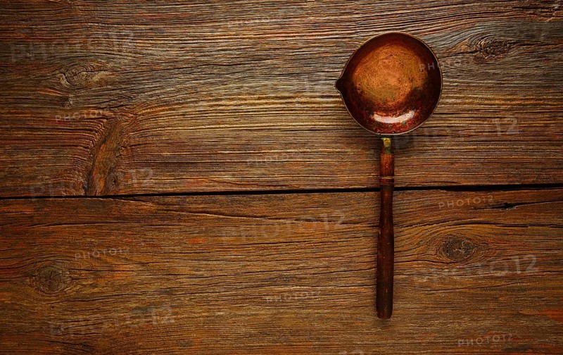 Aged cooper ladle vintage on wooden table retro