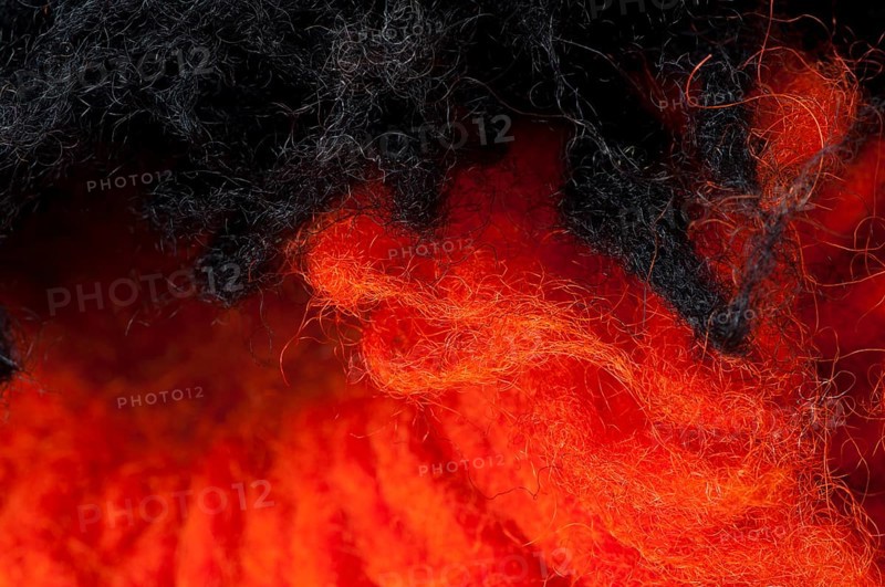 Black and red wool fibers closeup