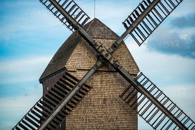 Large brown windmill in front of a blue sky in Berlin, Marzahn