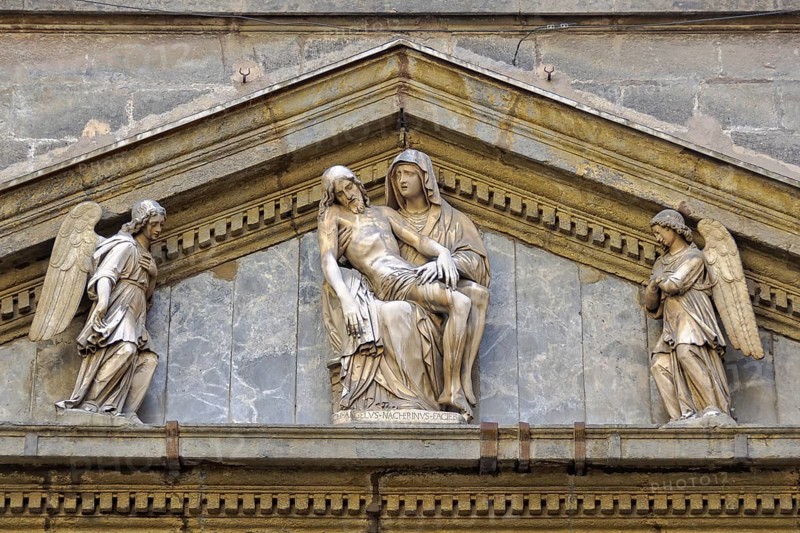 Sculpture of La Pieta by Michelangelo Naccherino in the tympanum above the entrance of the Chapel of Monte di Pieta, Naples, Campania, Italy, Europe