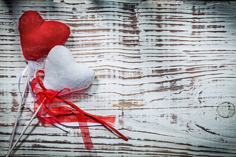 Valentine hearts with ribbons on wooden board holidays concept