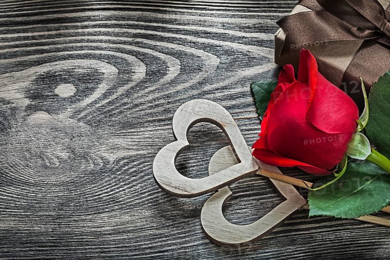 Wooden hearts red rose gift box on wood board holidays concept