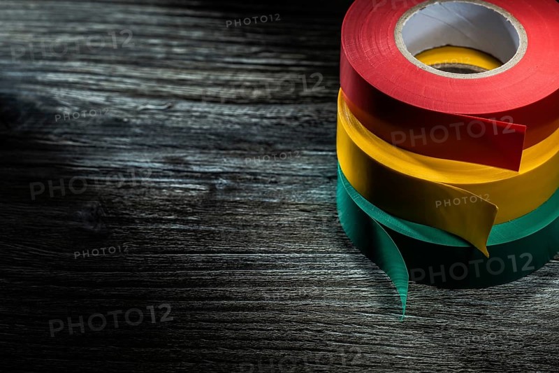 Rolled insulation tapes on wooden board