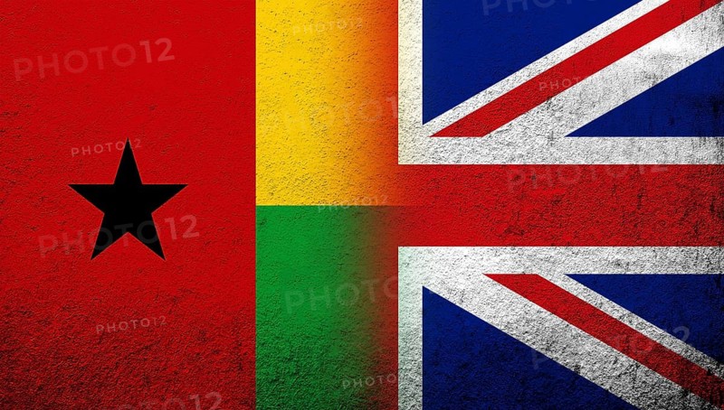 National flag of United Kingdom (Great Britain) Union Jack with The Republic of Guinea-Bissau National flag. Grunge background