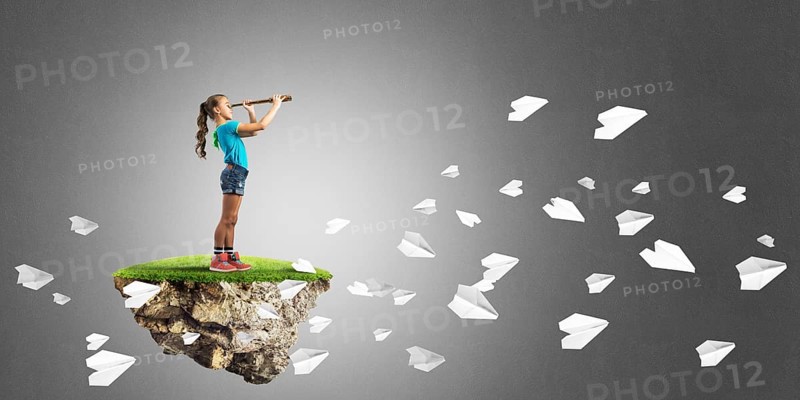 Cute kid girl sitting on floating island against concrete background