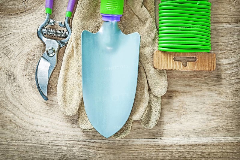 Working gloves secateurs hand spade garden soft tie on wooden board gardening concept