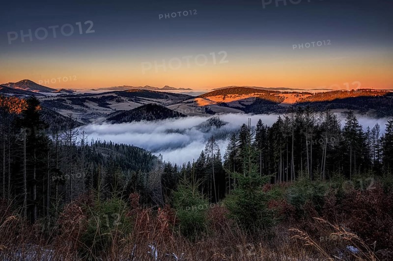 Fog over the Liptov village of Velke Borove before sunrise by Liptovska Mara in Slovakia