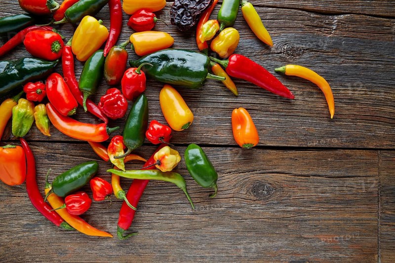 Mexican hot chili peppers colorful mix habanero poblano serrano jalapeno on wood