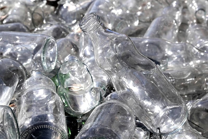 Bottle glass in a recycle bin mound