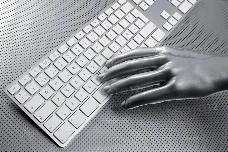 Computer keyboard aluminum gray hand silver background