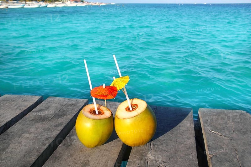 Coconut coktails in caribbean on wood pier turquoise sea