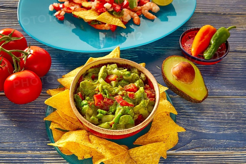 Guacamole with avocado tomatoes and nachos mexican food