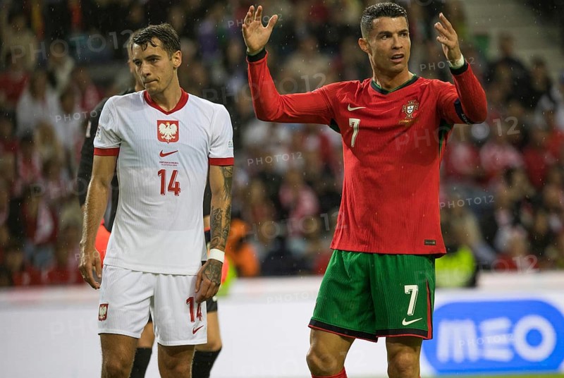 Football match, captain Cristiano RONALDO CR7 Portugal right. protests angrily with raised arms and hands towards referee Donatas RUMSAS Lithuania not to be seen, left. Jakub KIWIOR Poland looks sad and resigned to the bottom left, Estadio do Dragao, Porto, Portugal, Europe