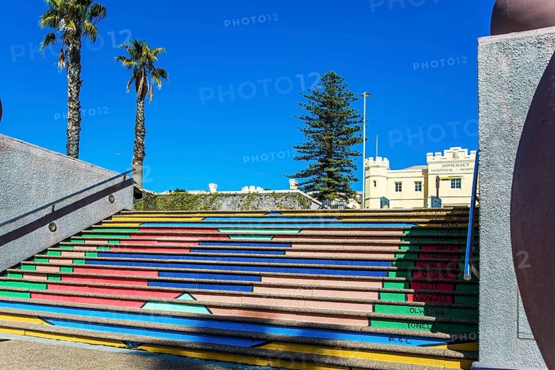 Multi-colored picturesque staircase descends to the port. Cape Town is a fabulous port city on the shores of two oceans. Mysterious South Africa. The concept of active, exotic and photo tourism