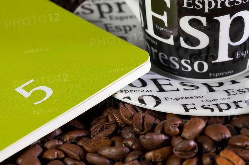 Coffee beans, cup of coffe and diary for May