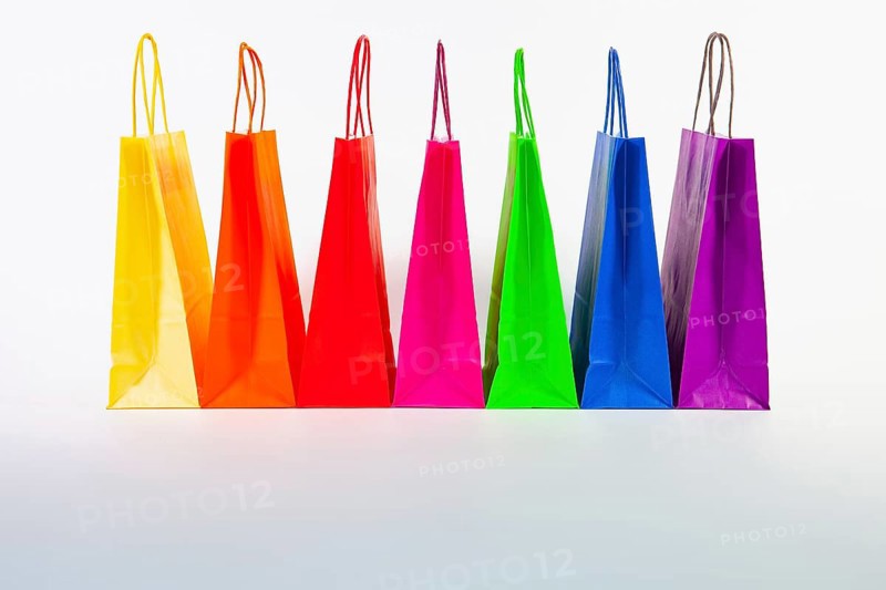 Set of colorful empty shopping bags isolated on the white background. Sale, consumerism, advertisement and retail concept. Many colorful shopping bags