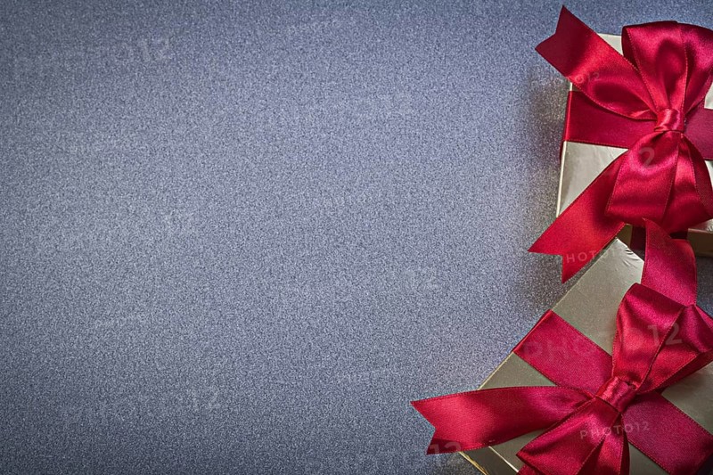 Giftboxes with red tapes on grey background holidays concept