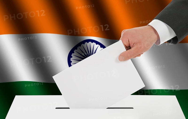 The Indian flag and the hand with the bulletin about the ballot box