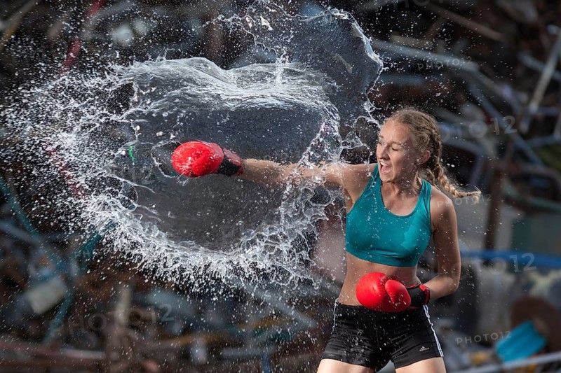 Boxer hits water balloon powerfully, proof of strength and determination, staged photo shoot, Mindelheim, Bavaria, Germany, Europe