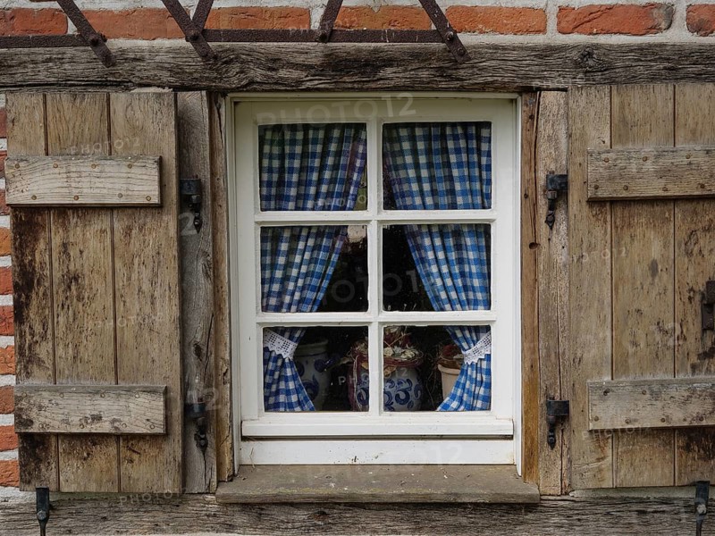 Rustic window with blue and white chequered curtains in a wooden frame, weseke, münsterland, germany