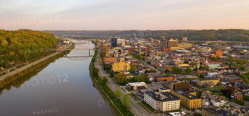 Sunrise reflects in the Kanawha River slowly flowing by picturesque Charleston West Virginia downtown