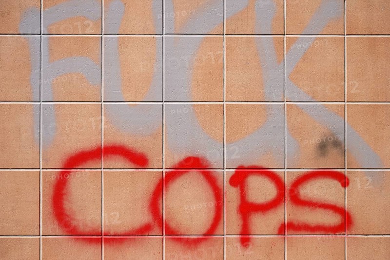 The political slogan Fuck Police on a tiled wall