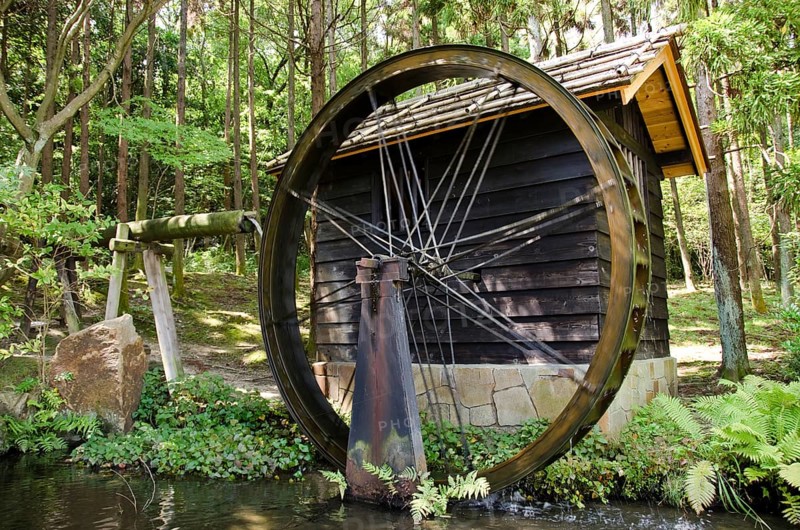 Small Japanese water mill running in the Expo Commemorative Park, Osaka, Osaka, Japan, Asia