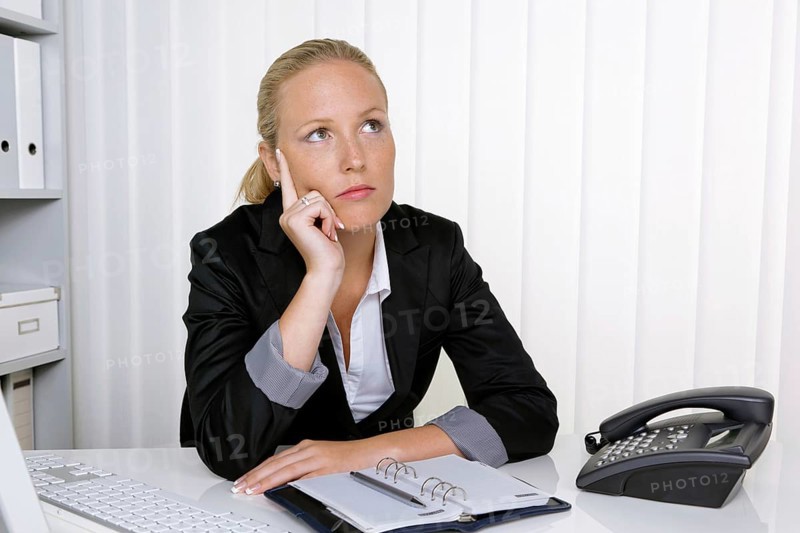 A secretary in the office at her daily work, 35 years, Thoughtful studio shot, Federal Republic of Germany