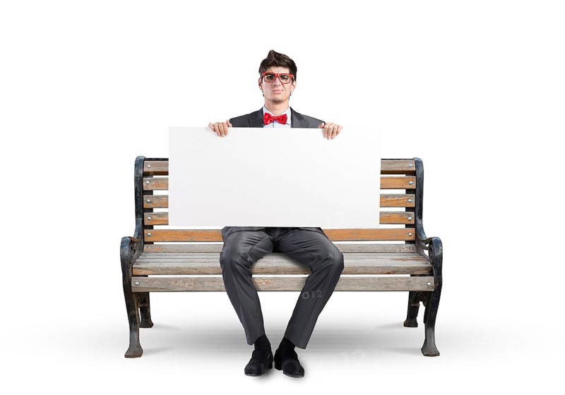 Young businessman holds a large white banner. sits on the bench
