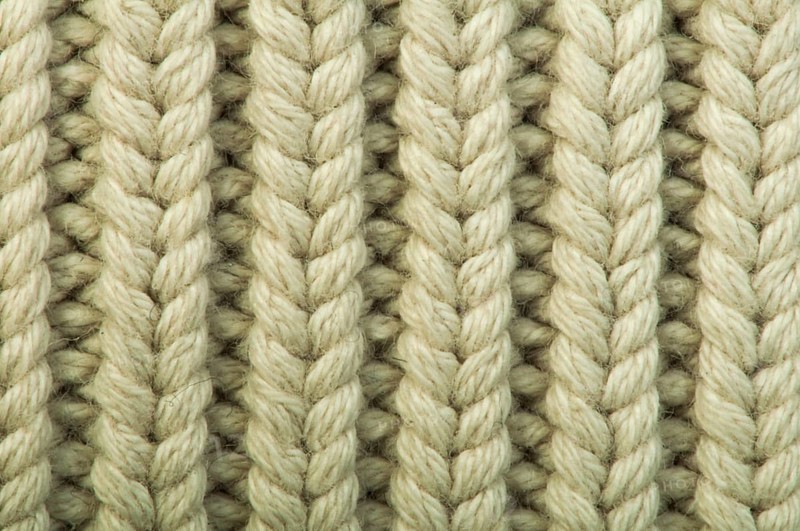 Old knit sweater background. Beige color. Studio shot