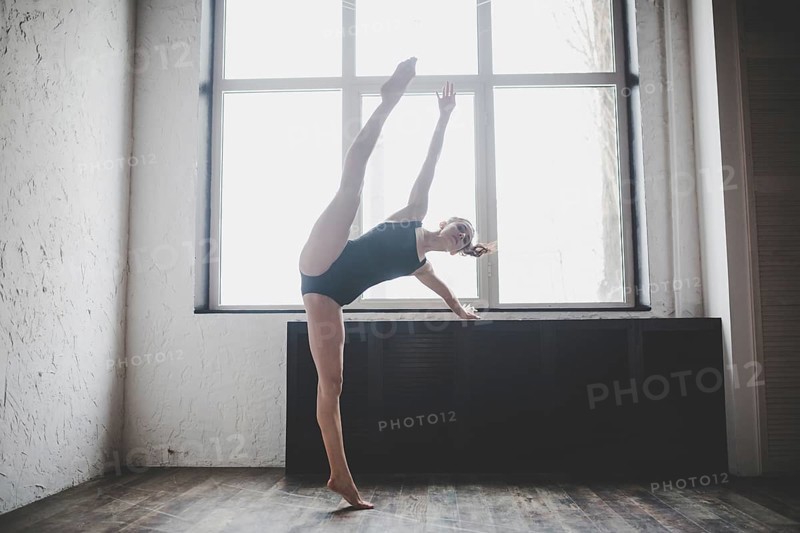 Plasticity slim woman dancing near window. Professional dancer enjoy dance. Lady Dancer Training Modern Ballet In Class. Contemporary dance performer. Daylight, silhouette beautiful body. Dance theme
