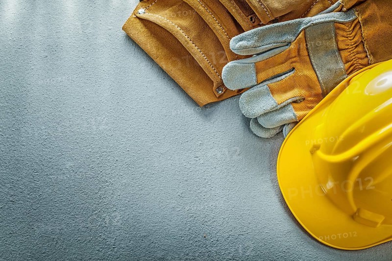 Tool belt safety gloves building helmet on concrete background
