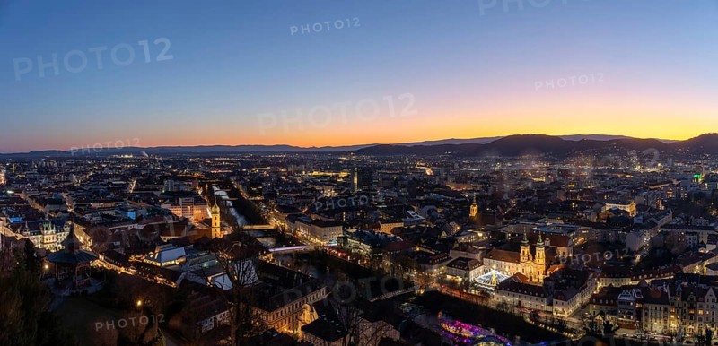 Evening mood, view from the Schlossberg to the illuminated Murinsel and the Mariahilferkirche, panoramic shot, historic city centre of Graz, Styria, Austria, Europe