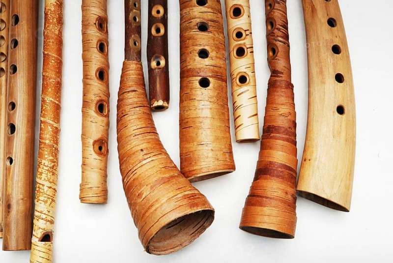 Ancient woodwind folk instruments on a white