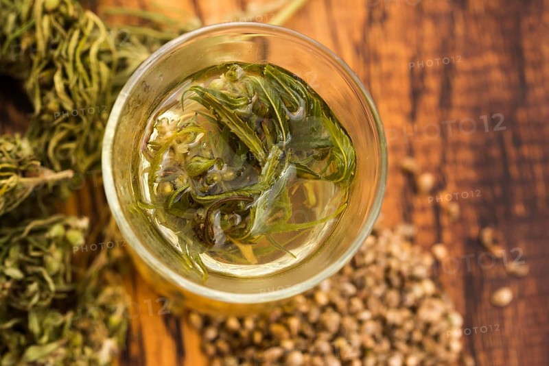 Cannabis herbal tea on wooden background