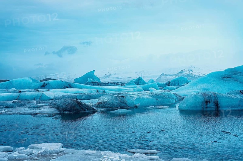 Blue icebergs floating in a frigid body of water, surrounded by snowy mountains, iceberg Iceland, glacier, snow, ice rock, ice diamont, glacier lagoon, nature, snow, diamont beach, Iceland, Europe