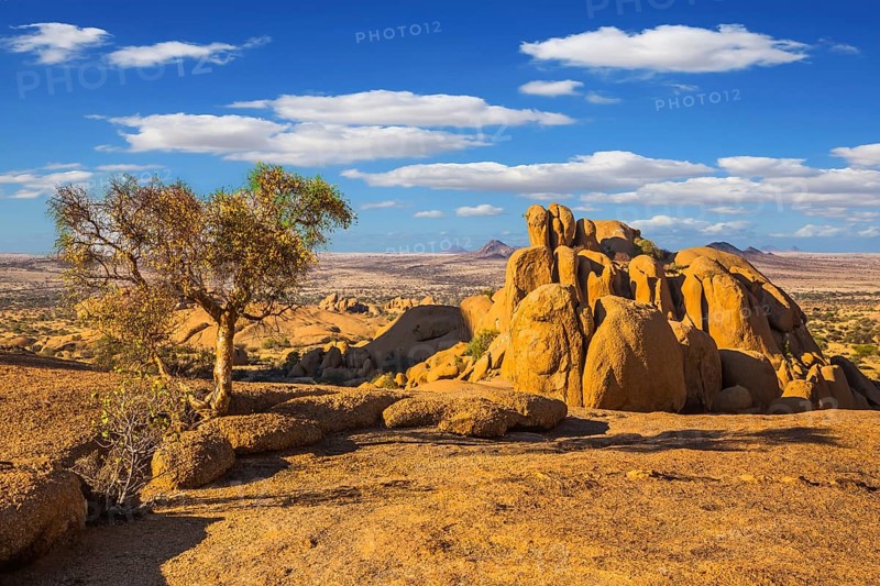 The granite outcrops in the Desert Namib. Stone of Spitzkoppe, Namibia. Play of light and shadow on the rocks. Concept of extreme and ecological tourism
