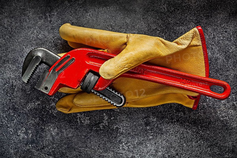 Monkey Wrench On Yellow Working Gloves