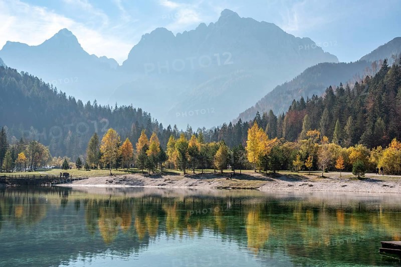 Scenic autumn forest at Crystal Lake in the Julian Alps, Slovenia, Europe