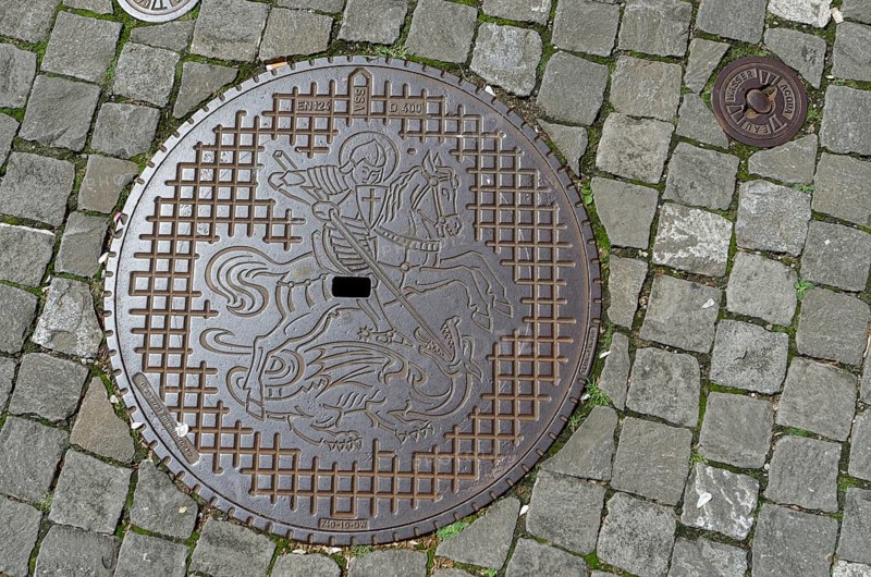Manhole cover with coat of arms of the municipality of Stein am Rhein, dragon slayer, Canton Schaffhausen, Lake Constance, Untersee, Switzerland, Europe