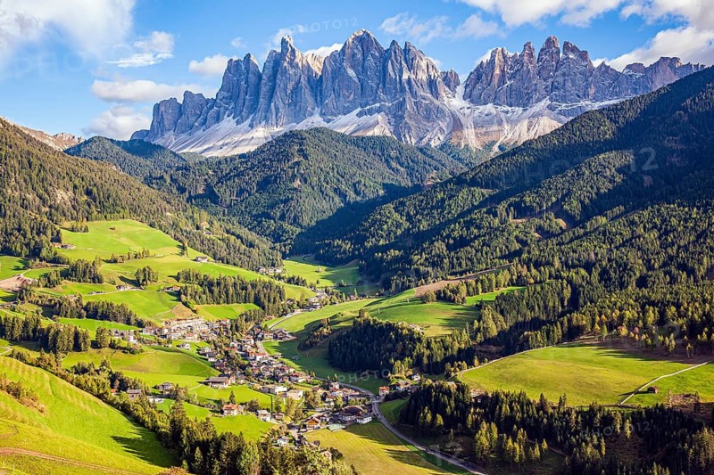 Fabulously beautiful valley in South Tyrol. Charming old little church in the Val de Funes. Dolomites on a sunny autumn day. The beautiful village in the Dolomites Santa Maddalena