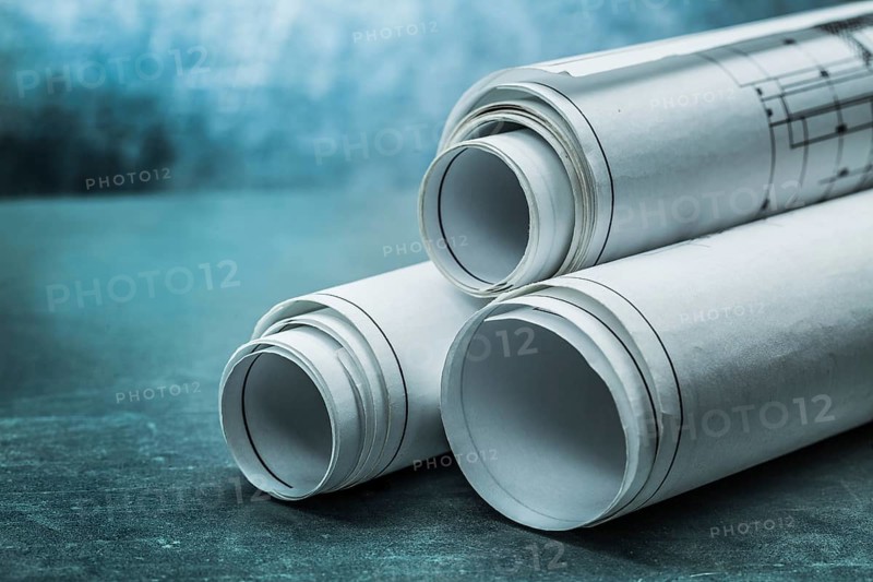 Rolls of blueprints on metalic background
