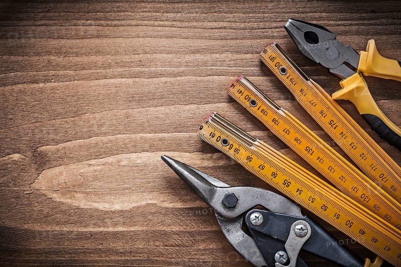 Set of steel cutter pliers wooden meter construction concept