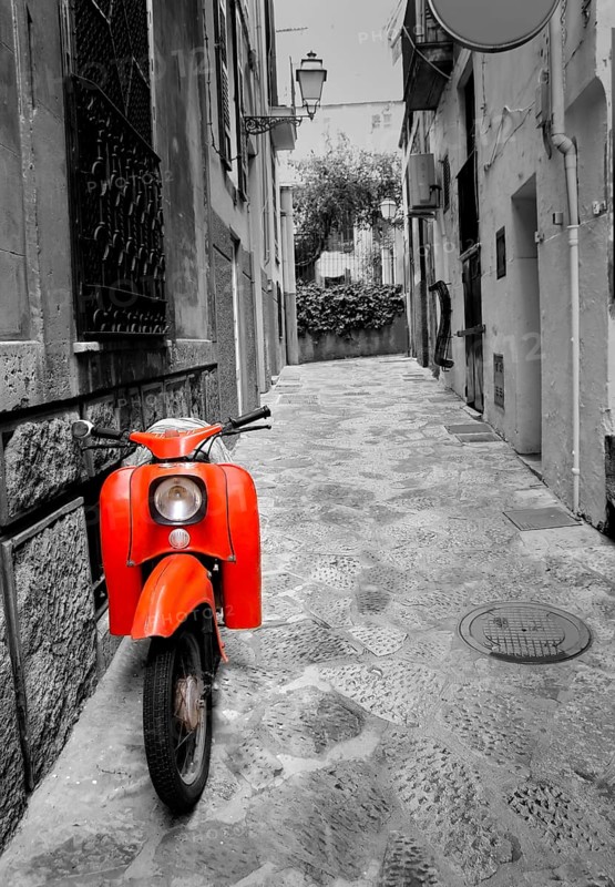 Mediterranean street with old retro red scooter in Palma de Mallorca Spain